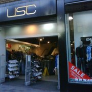 Pedestrians Walk By A Usc Clothing Store On Princes Street Stock