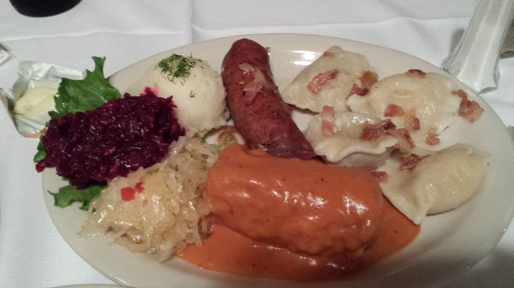 Polish platter. Cabbage roll, perogies, Polish sausage, sauerkraut
