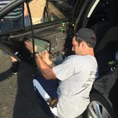 Auto Glass Solutions - Austin, TX, United States. Mobile Window installation technician (Dimitrios) working hard.