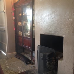 Photo of The Cottage Tea Room - Dublin, Republic of Ireland. Delph cabinet and old fireplace