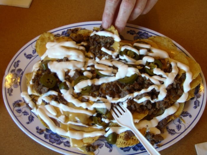 Carne Asada Nachos Supreme with marinated jalapeno slices, pico de gallo, drizzled sour cream Carne Asada Nachos Supreme with marinated jalapeno slices, pico de gallo, drizzled sour cream