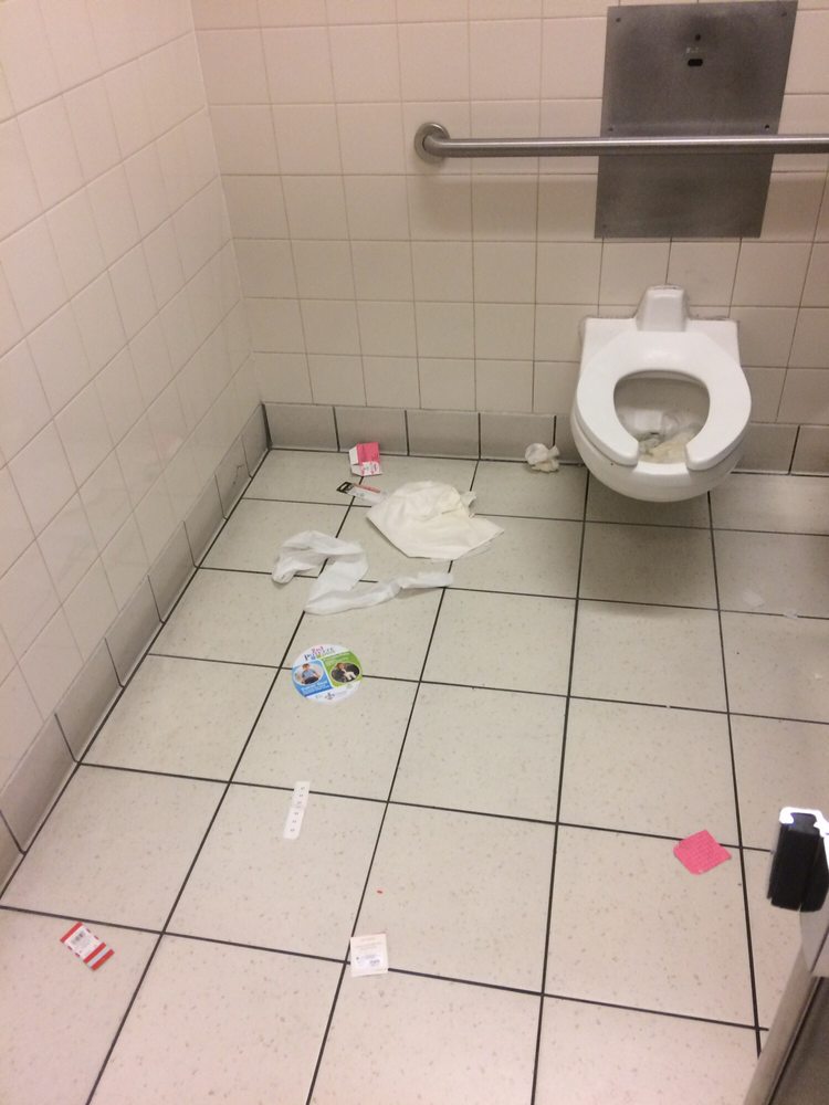 disgusting handicap stall in women s bathroom with clogged toilet
