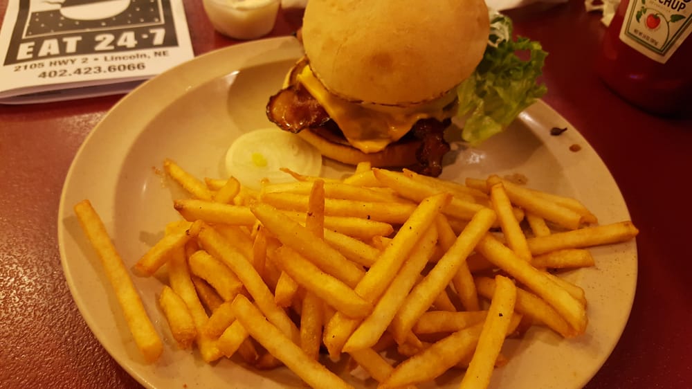 Bacon cheeseburger with fries. One tomato, two pickes, onion, lettuce