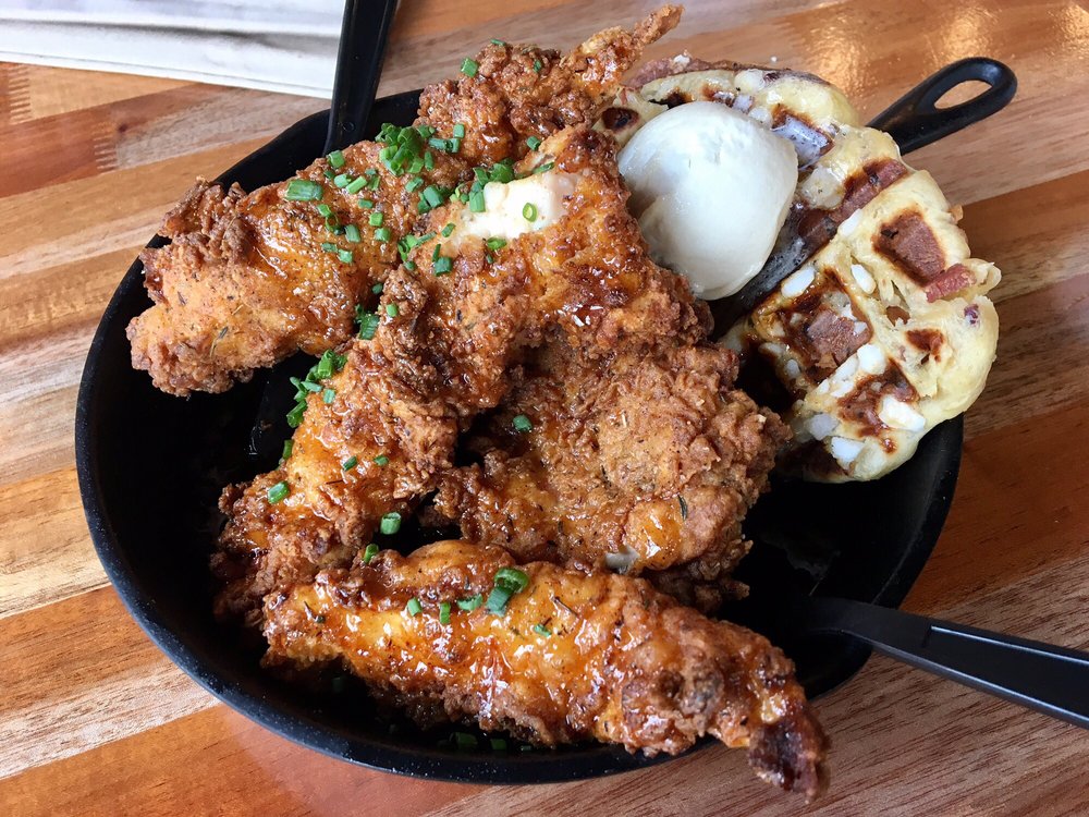 Original Chicken & Waffle Skillet covered in maple syrup. Waffle is