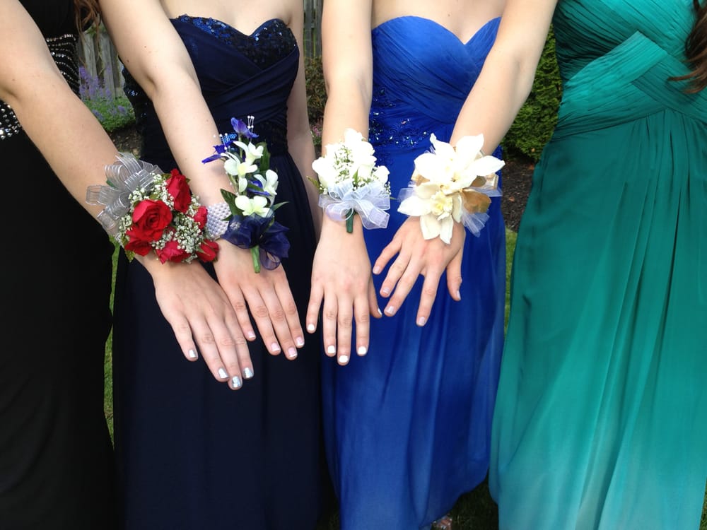 Second corsage from the left corsage of white orchids and blue