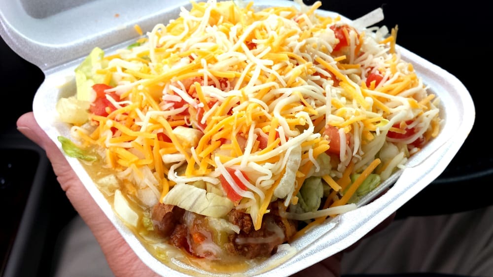 Small frito pie w/ green chili sauce, ground beef, refried beans