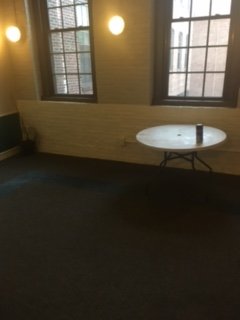 dead flowers and dirty old table are left in the hallways as