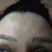 Narisara 3D Eyebrow - Salt Lake City, UT, United States. Note the grey 'spots' neath each brow, and the huge difference in brow shape on either side.  This is due to a lack of skill.