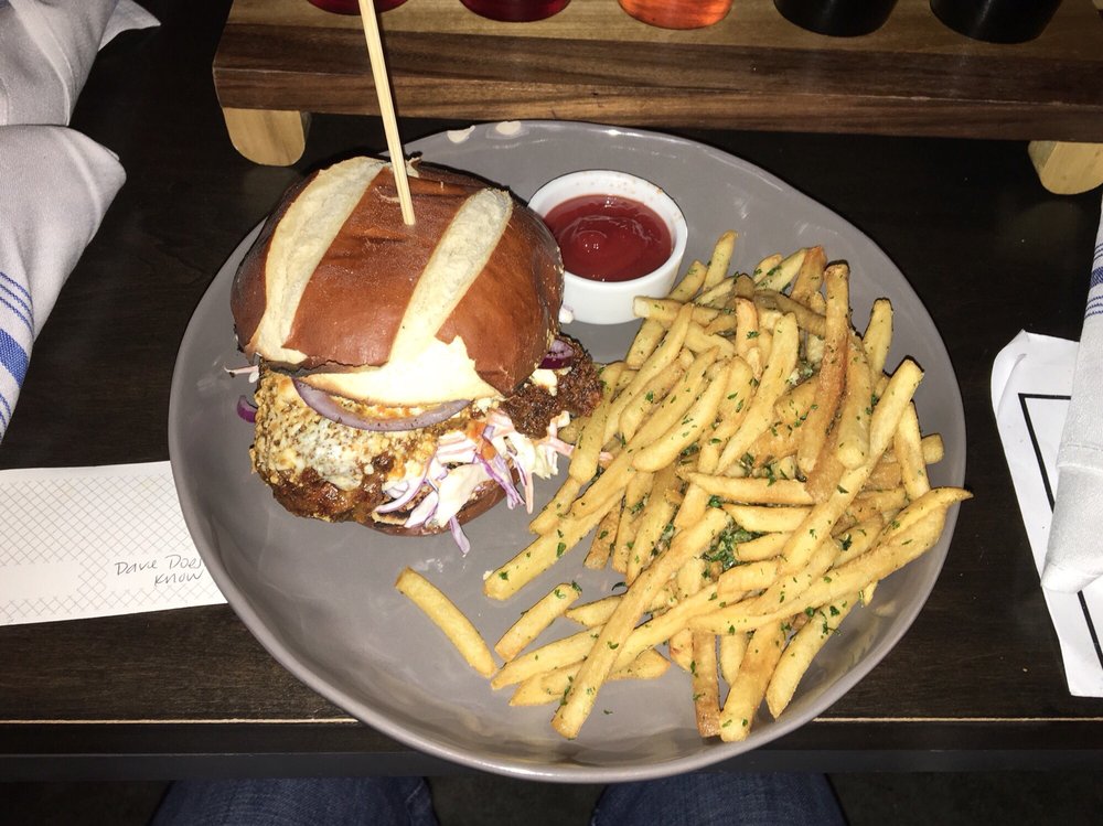 buffalo kentucky fried chicken sandwich with side of garlic fries